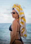 Soft, absorbent, and stylish in our Lemon Stripe print. The Honëlo towel is the perfect accessory for your golden hour beach sessions.