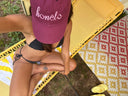 Honëlo Beach Day Cap in Merlot with embroidered logo, worn at the beach