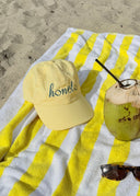 Shade your face in style. The Honëlo soft cotton cap with embroidered logo.